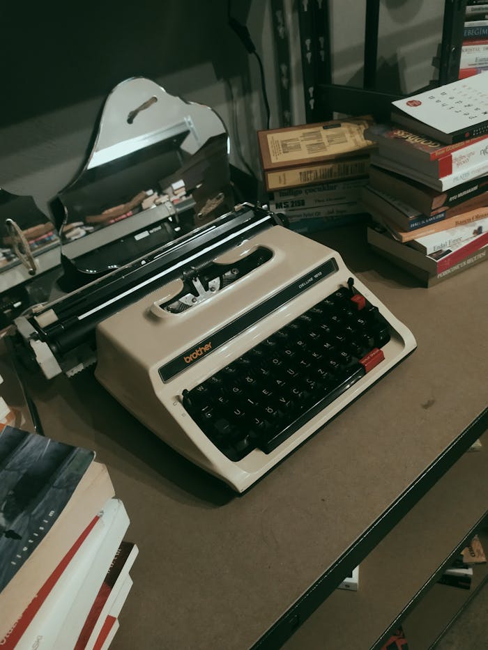 A retro typewriter on a desk surrounded by stacks of books, encapsulating a classic literary vibe.